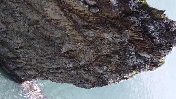 Vertical orientation video: An unusual rock standing in the sea