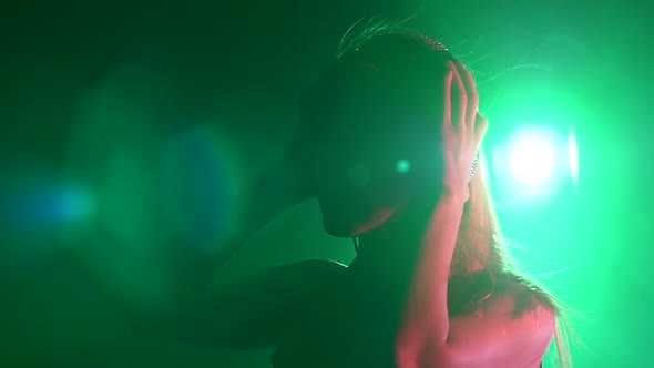 Sexy Blonde Dj Girl Playing and Listening To Music, Touching the Headphones, Smoke, Silhouette, Slow alt