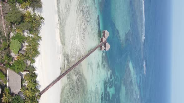 Vertical Video House on Stilts in the Ocean on the Coast of Zanzibar Tanzania Aerial View alt