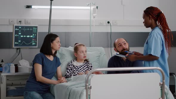 African American Pediatrician Asisstant Monitoring Sick Patient Discussing Medicine Treatment alt