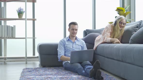 Smiling business blonde, white man person working from home on sofa with computer alt