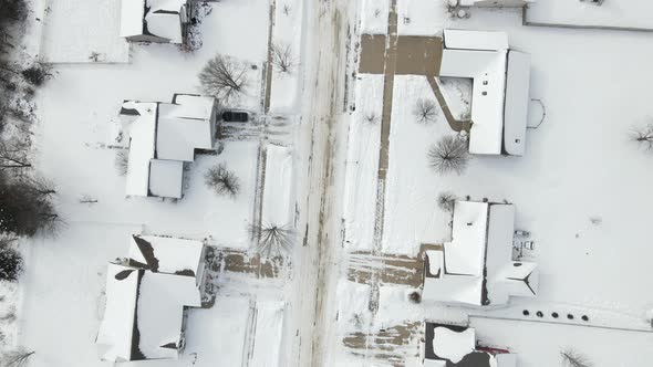 Top down view over rural snow covered residential neighborhood in winter.