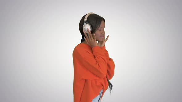 Happy African Woman Wear Wireless Headphones Listening Music on Gradient Background. alt