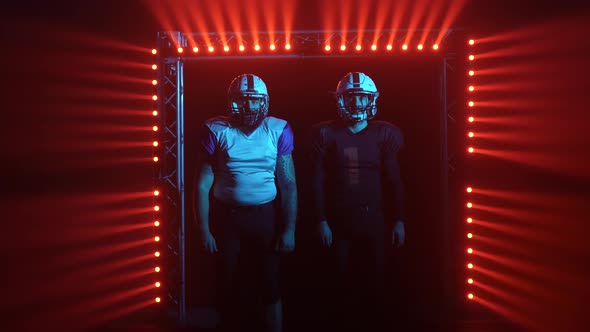 Two American Football Players in Sports Helmets and Uniform Enters Stadium alt