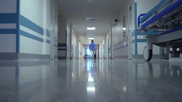Doctor Walking through the Long Hallway
