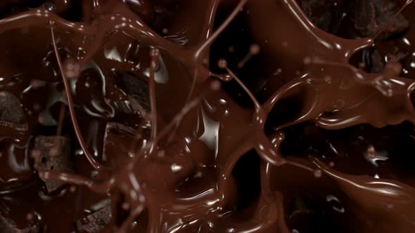 Super Slow Motion Shot of Raw Chocolate Chunks Falling Into Melted Chocolate at 1000 Fps alt
