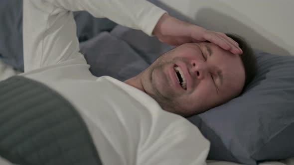Close Up Casual Man Having Headache While Sleeping in Bed alt