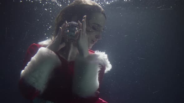 A Beautiful Woman in a New Year's Dress She Floats Under the Water Next To the Surface From Which alt