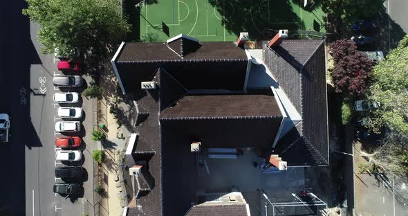 Drone footage capturing church recently converted into a school which active renovations undertaken alt