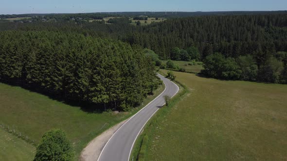 Road in nature reserve Eifel in Germany near Kalterherberg, hills and forest alt