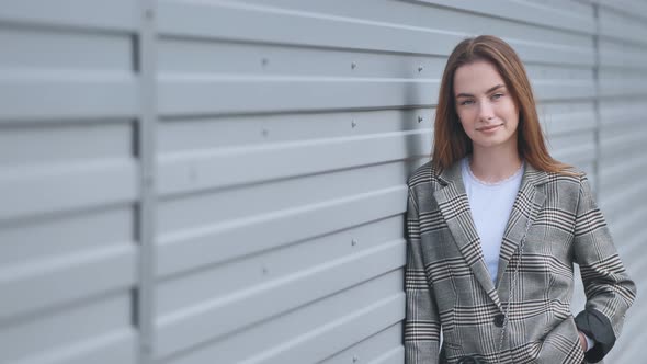Portrait of a Young Girl in a Blazer By a Wall on the Street alt