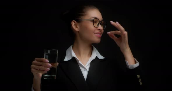 Business Woman Drinks Vitamin with Water From a Glass Gives a Thumbs Up