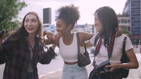 A group of multi-ethnic female friends enjoying the city tour. alt