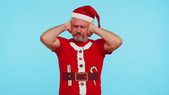 Man in Christmas Tshirt Covering Ears and Gesturing No Avoiding Advice Ignoring Unpleasant Noise alt