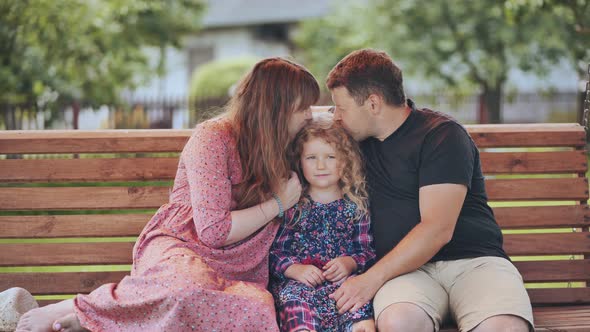 A Young Family on a Swing in the Garden alt