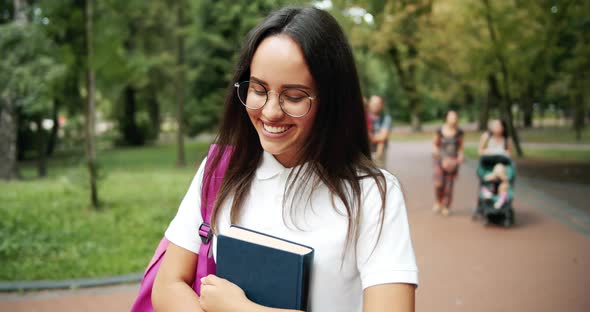 Smiling Student Girl Walking in Park