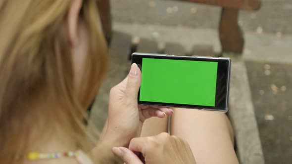 Caucasian woman in the park with greenscreen display tablet 4K 2160p 30fps UHD footage - Outdoor on  alt