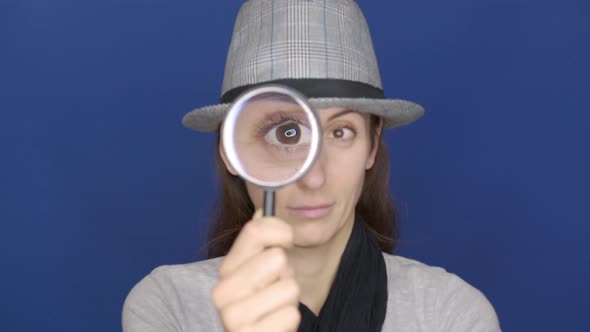 Funny Girl Looking Throw Magnifier To the Camera  alt