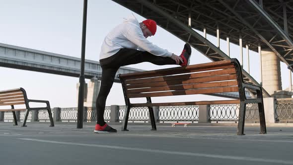 Stretch Man Training Urban. Young Flexible Male Stretches Deeply in Urban City Surroundings, in Slow alt