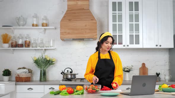 Smiling Woman Housewife Slices Bell Pepper Tells Chef Study Online Video Call alt