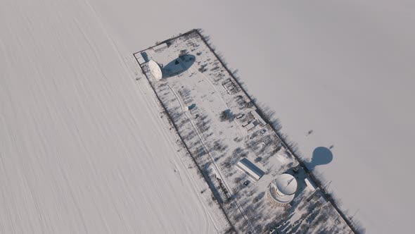 Aerial View of the Space Communication Station in Snow Covered Field at Sunny Winter Day Drone