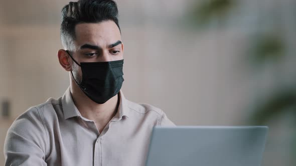Arabian Sick Businessman in Medical Mask Designer Programmer Typing on Laptop Search Information in alt