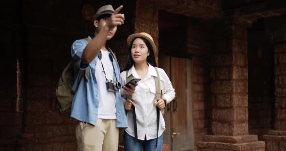 Couple checks location on smartphone online map alt