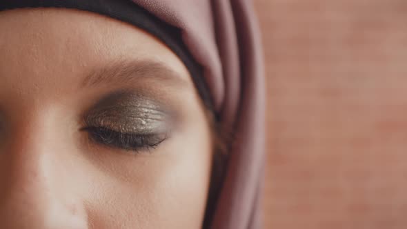 The Opening Eye of a Muslim Woman. Close Up of a Painted Muslim Eye Slowly Opens alt