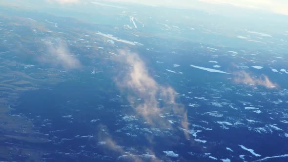 Plane soaring through cloud, aerial view of city and ocean nature landscape winter slow motion video