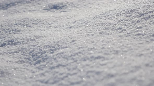 Close-up of snow dunes on the early morning 4K 3840X2160 UHD tilting video - Shallow DOF of frozen c alt