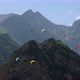 Paragliding Pilots Fly Paragliders Among Clouds and Green Mountains - VideoHive Item for Sale