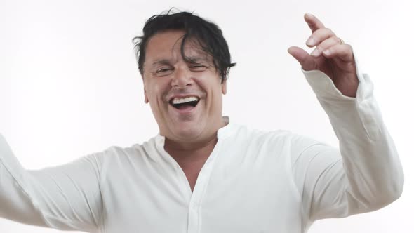 Closeup of Chubby Middleaged Man in Casual White Tshirt Smiling and Laughing Having Fun Looking alt