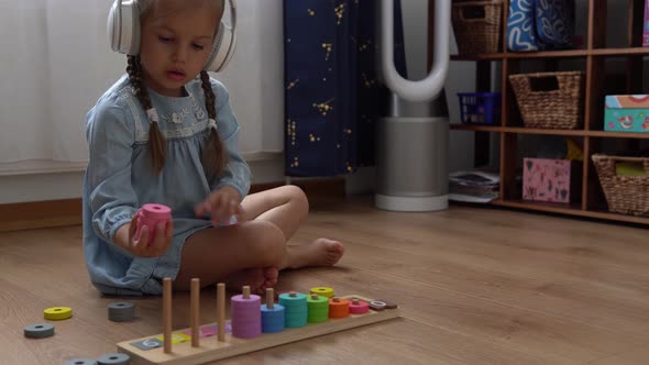 Happy Little Preschool Toothless Girl Playing With Colored Wooden Toy
