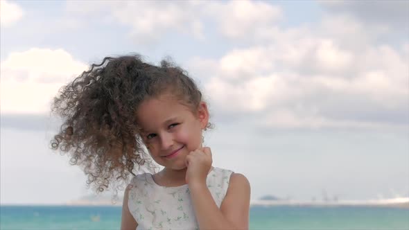 Close-up Portrait of a Beautiful Little Girl, Cute Smiling, Looking at the Camera alt