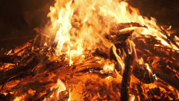 Hot Coals Burning Down a Large Fire and Glow Bright Red. Slow Motion alt