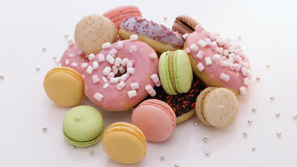 Macaroons and Donuts Rotate on White Background