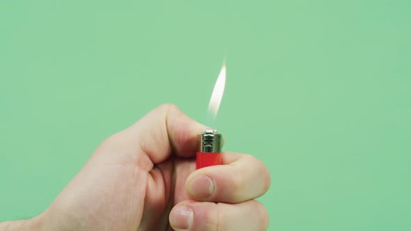 Hand igniting a lighter alt