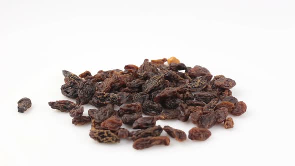 Close-up a Handful of Sweet Raisins Rotate on a White background.Sweet Organic Raisins Rotate on a