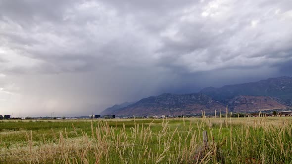 Lightning striking as storm moves over mountains in timelapse alt