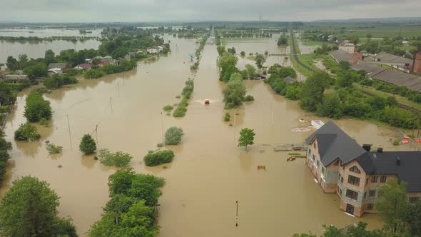 Special Vehicles Are Moving on the Flooded Road After the Flood. Flooded City of Halych Aerial View
