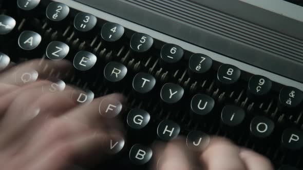 A man typing on a typewriter