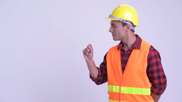 Young Happy Hispanic Man Construction Worker Touching Something alt