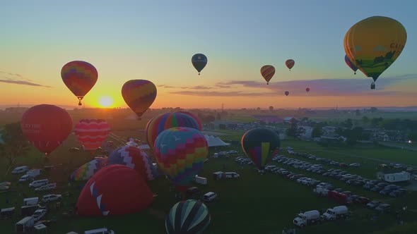 Aerial View of a Morning Launch of Hot Air Balloons at a Hot Air Balloon Festival at Sunrise  alt