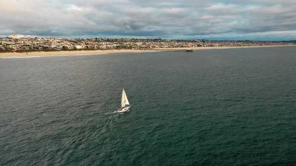 Boat Sails In The Manhattan Beach Coast In California. - aerial alt