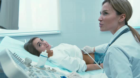 Smiling pregnant woman at ultrasound examination