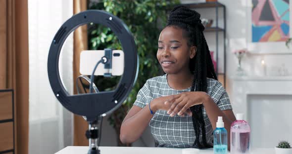 A Popular Influencer Vlogger Creates a Video on Social Media Talking Into Phone Set Up on Ring Light alt