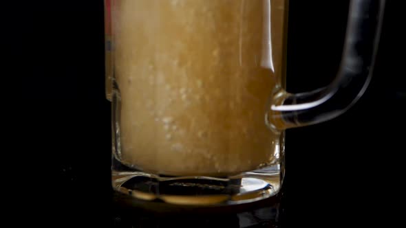 Macro shot of pouring beer in a glas. alt