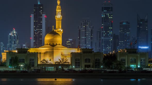 Modern Dubai City Skyline Timelapse with Rashid Al Hadeeth Mosque at Night with Illuminated alt