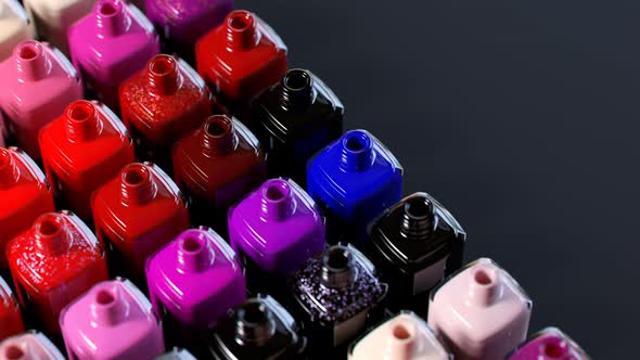 Multi-colored nail polish bottles arranged by shade Seamless animation. 4k HD alt
