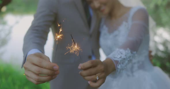 Happy Asian Bride And Groom In Wedding Dress Burning Sparklers Bengal Lights alt